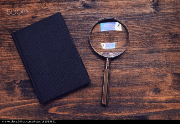 500px Photo ID: 181515831 - Loupe magnifying glass and notebook on wooden desk, top view, concept of searching and investigating